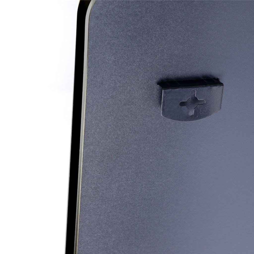 Close-up of small black plastic mounting clip with cross-shaped slot on dark grey MDF board, left edge showing gold alumin…