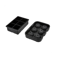 Black silicone ice tray set of two; 6-cavity square tray on left, open 6-sphere round mould on right, angled top view