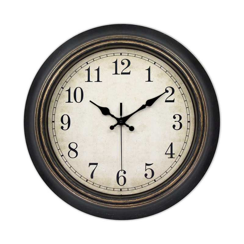 Round wall clock with black frame, aged cream dial, Arabic numerals, and black hands on white background