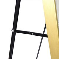 Close-up of black metal spreader bar with silver bolts connecting the easel legs, gold brushed aluminum frame visible at r…
