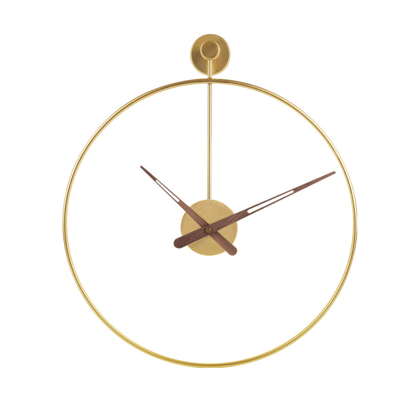 Gold open-face wall clock with thin circular iron ring frame, walnut-tone hands, and top wall-mount bracket, front view on…