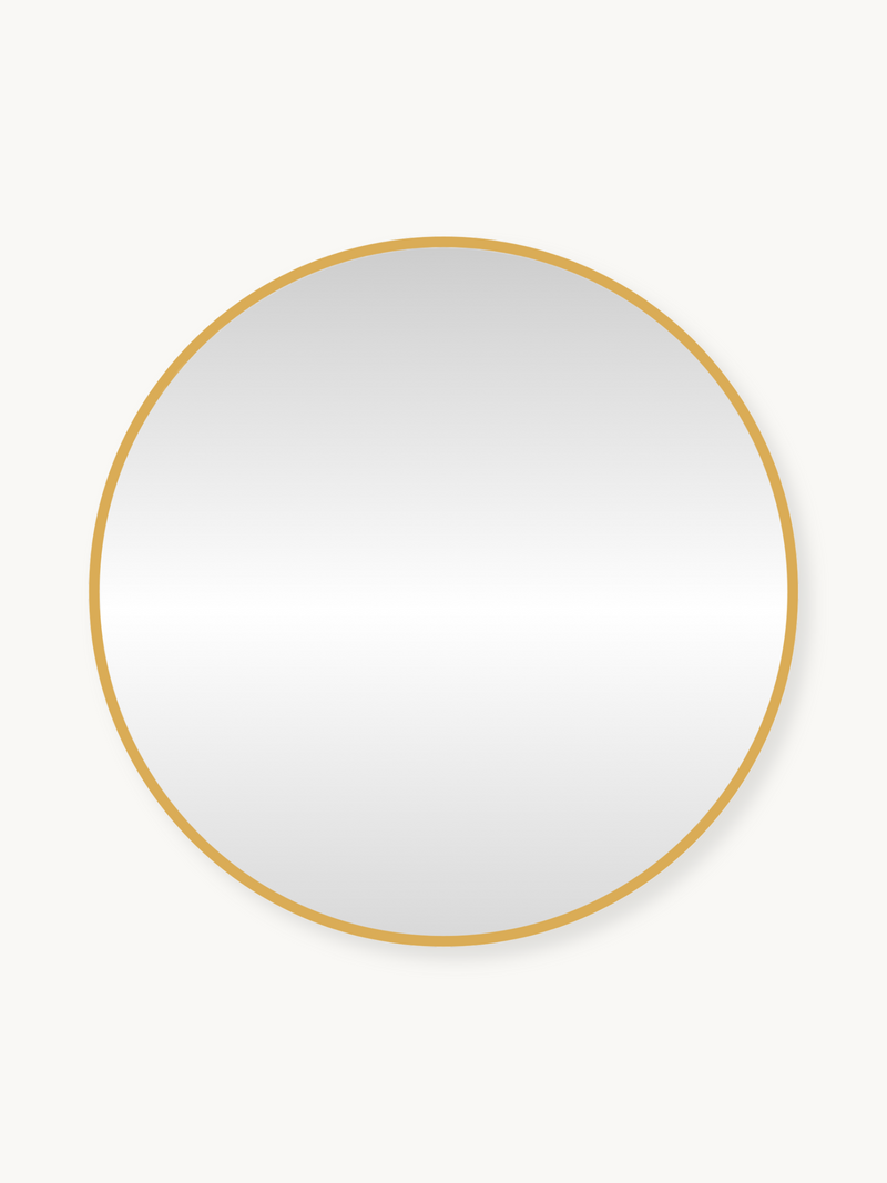 Round wall mirror with slim gold metal frame, front view on off-white background