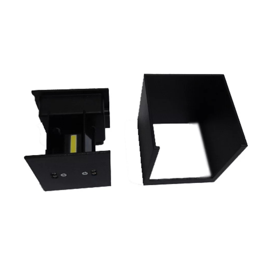 Black cube LED wall lamp disassembled: base unit with yellow COB LED chip and screw terminals beside empty square housing…