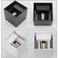 Four-panel comparison of cube LED wall lamps: two black and two white finishes, each shown from above revealing internal C…