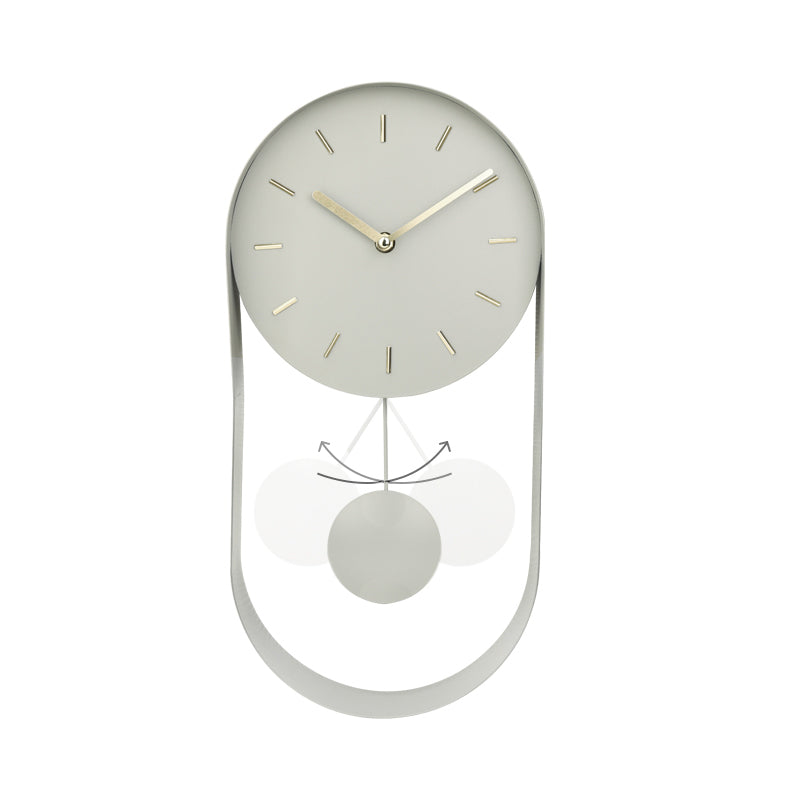 Pale green pendulum wall clock front view, oval open metal frame below dial, motion arrows indicating swinging bob