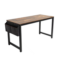 Rustic brown wood-look desktop on black metal frame desk, angled view showing attached dark grey fabric side storage bag,…