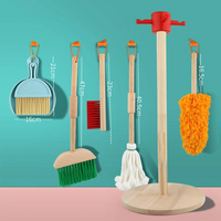 Children's wooden cleaning playset with dimension labels showing broom 47cm, mop 40.5cm, duster 16.5cm, dustpan 21cm, on t…