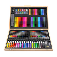 Open light wood case overhead view showing markers, crayons, coloured pencils, oil pastels, and watercolour pans in black…