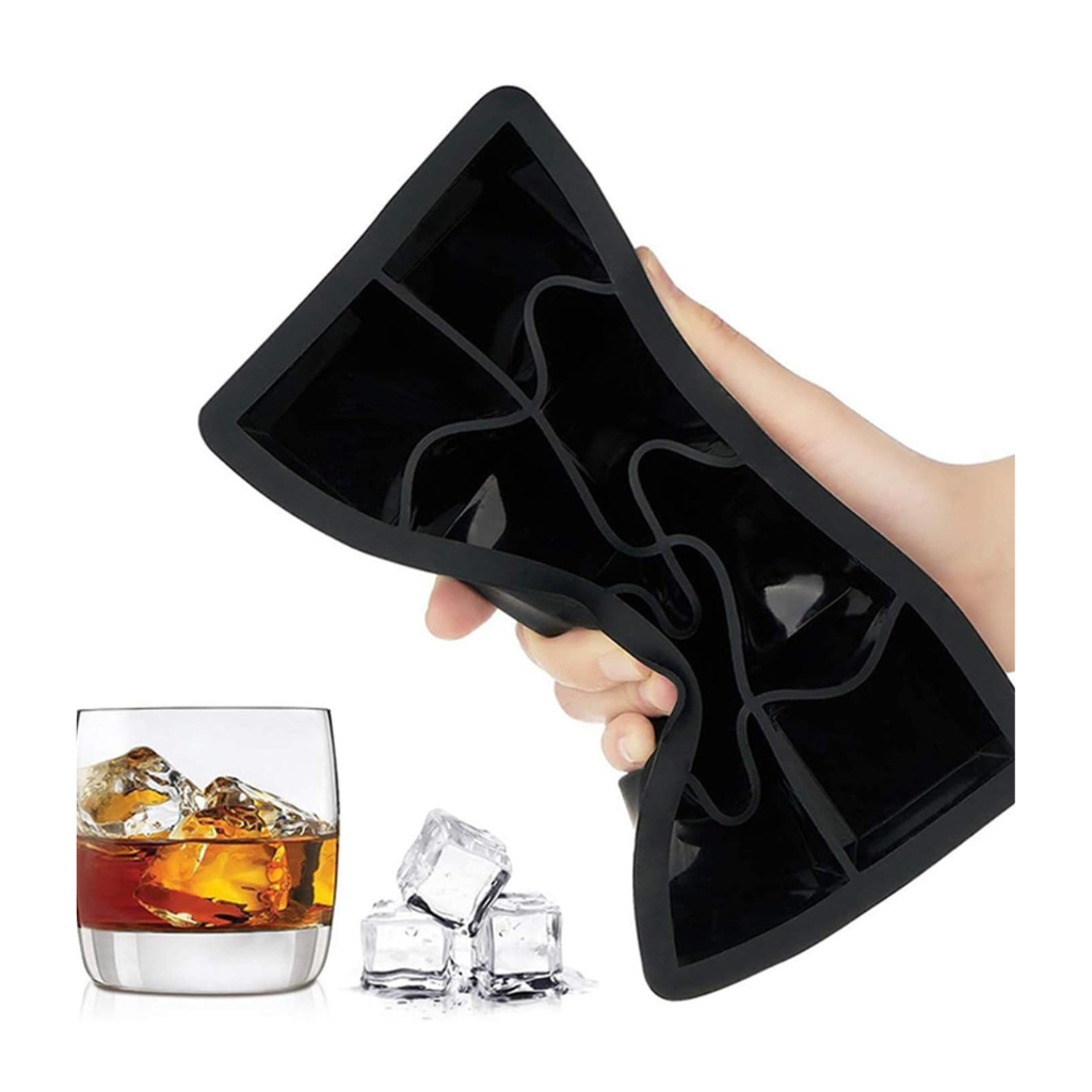 Hand flexing black silicone ice cube tray showing its bendable edges, with loose large ice cubes and a whisky glass below
