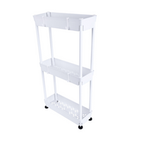 White 3-tier slim metal utility rack on casters, perforated lower shelves and solid top tray, angled front view on white b…