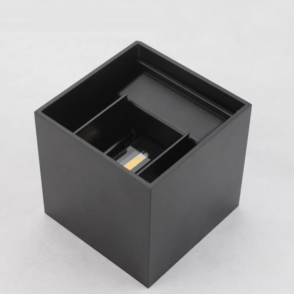 Black matte cube LED wall lamp seen from above at an angle, top open showing internal LED chip and adjustable light direct…