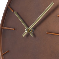 Close-up of brown resin clock face showing gold-tone hands at centre pivot and copper-tone dash hour markers