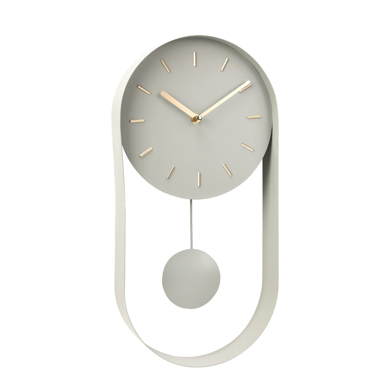 Pale green iron wall clock, angled view showing round dial with gold hands and dash markers, oval frame with hanging spher…