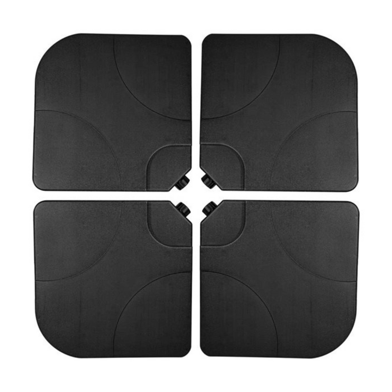Four black plastic parasol base tiles arranged in a 2x2 grid, showing curved cutouts at centre where pole fits, top-down view