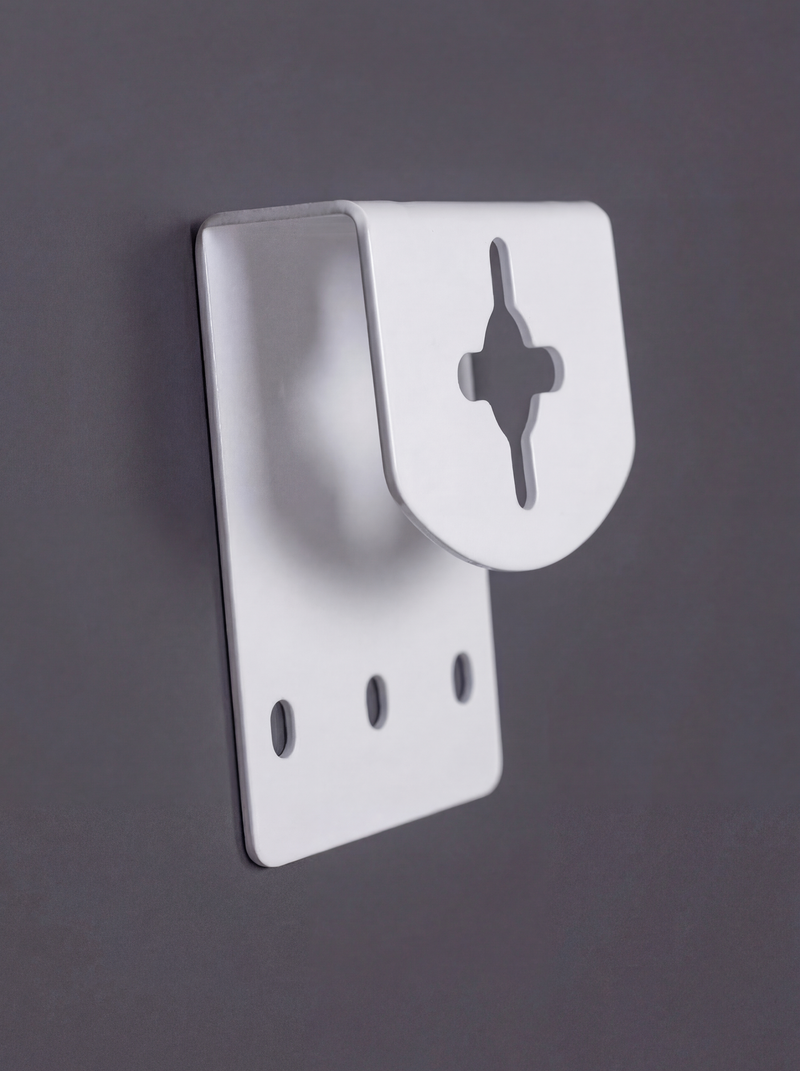 White metal wall mounting bracket with cross-shaped keyhole slot and three oval screw holes, angled view on grey background