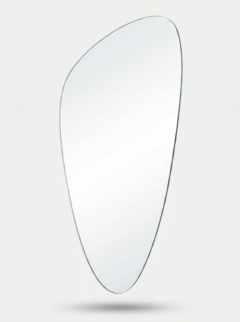 Frameless asymmetric teardrop-shaped mirror on white background, angled view showing slim edge profile and clear glass sur…