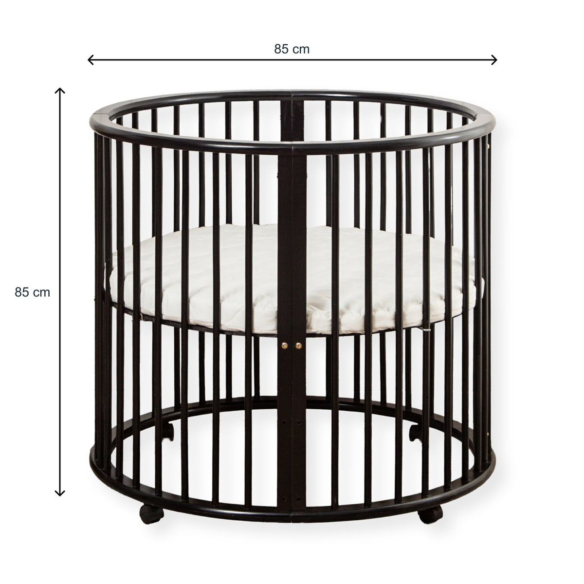 Black round wooden baby playpen with dimension annotations showing 85 cm width and 85 cm height, white mattress inside, on…