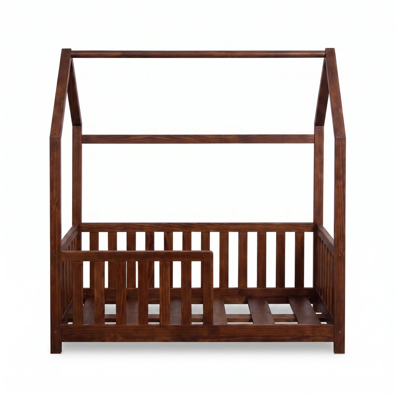 Walnut brown wooden children's house bed, straight-on front view, slatted safety rails on three sides, no mattress, white…