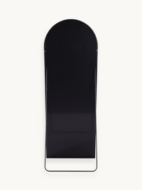 Back view of black aluminium arched full-length mirror showing rear panel, metal support struts, and curved floor stand base