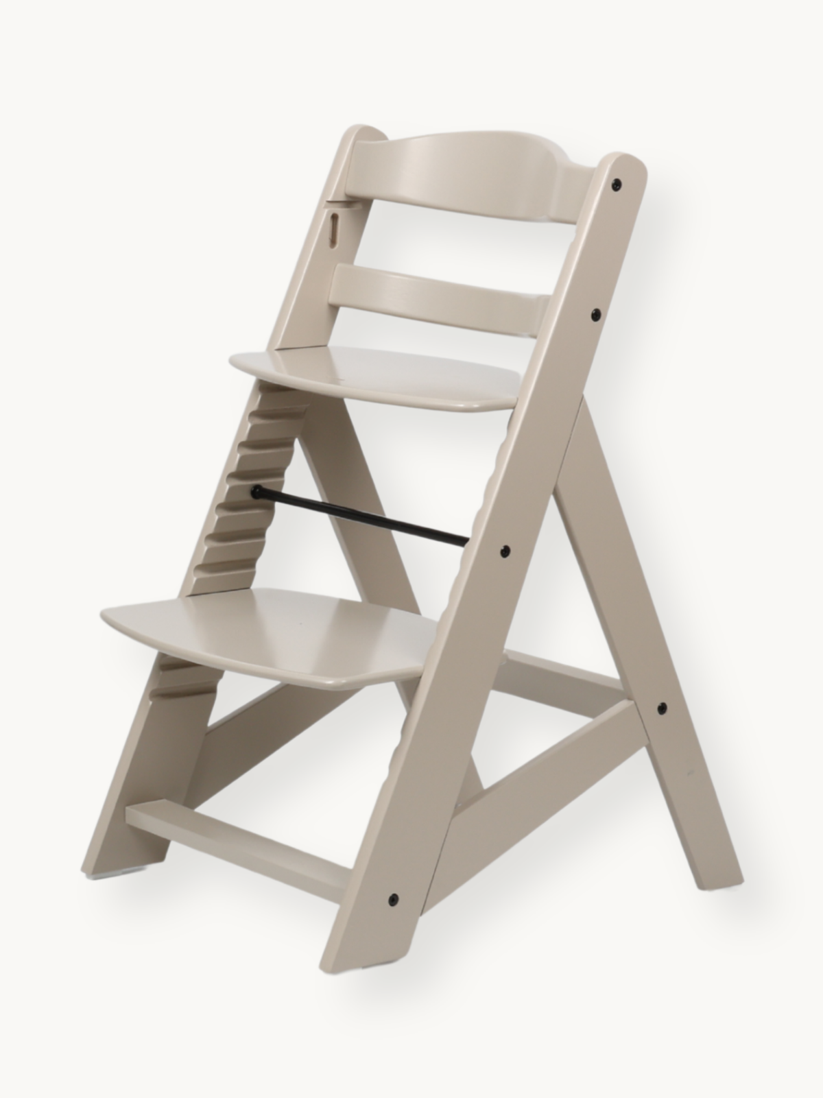 Clay beige wooden highchair angled view, no tray or harness, showing adjustable seat and footrest slots on left rail, blac…