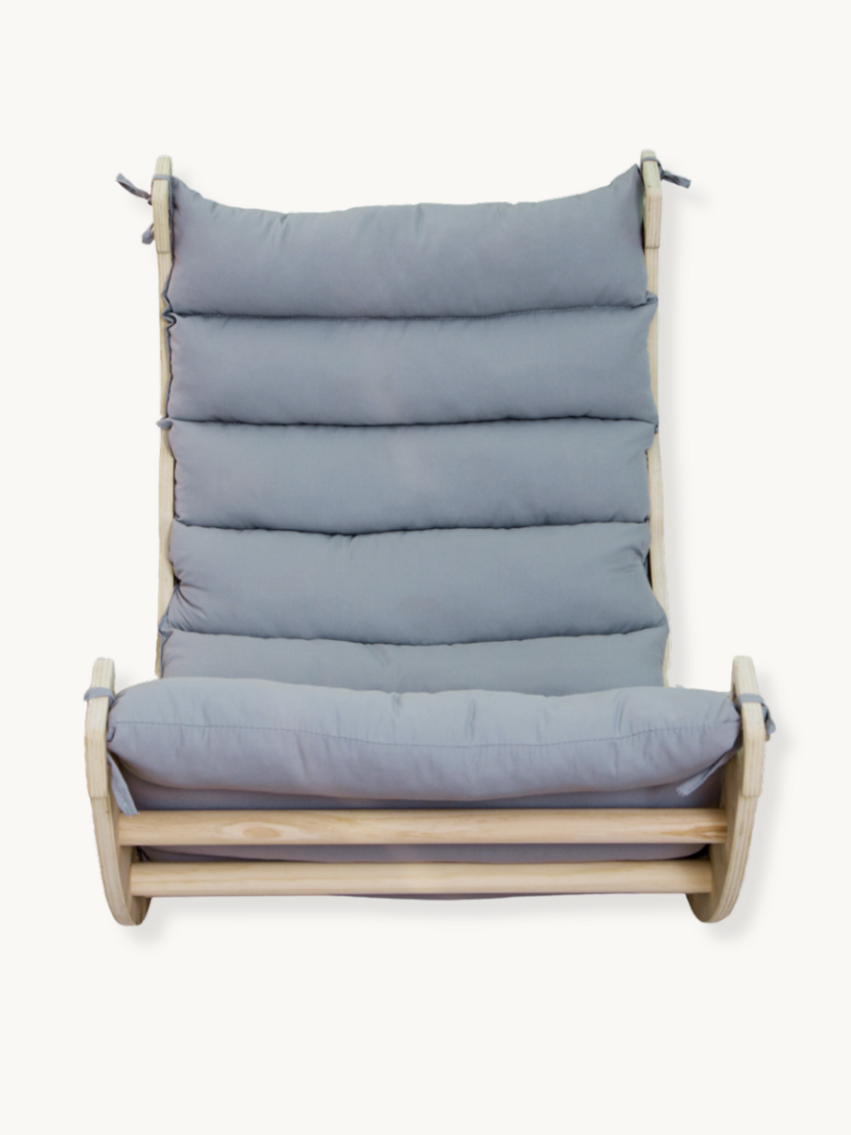 Front-on studio view of natural wood climbing arch rocker with grey padded cushion fitted across seat and high backrest