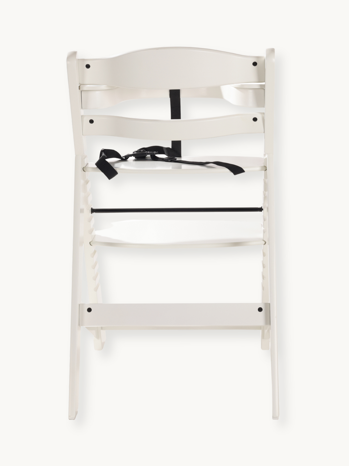 White wooden baby high chair rear view showing black safety harness with buckle and horizontal footrest bar detail.
