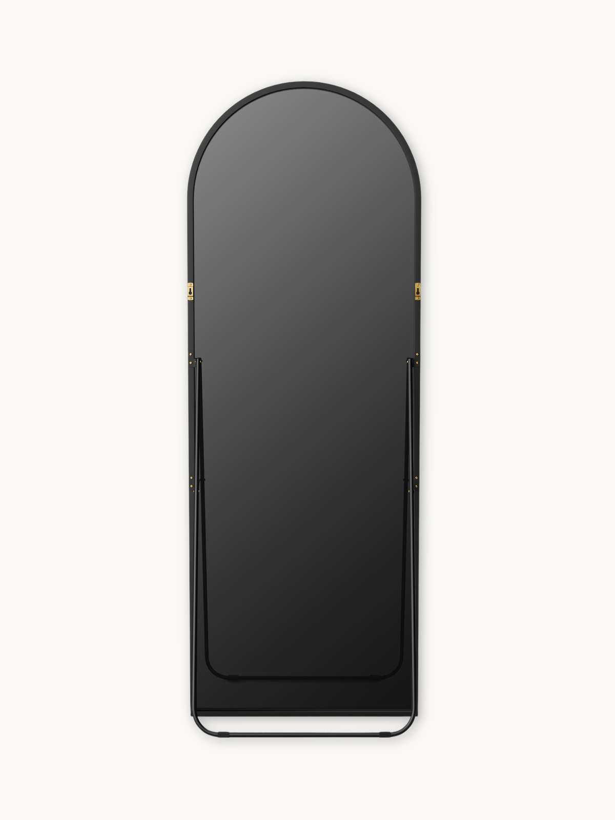 Front view of black aluminium arched full-length mirror showing gold wall-mount brackets mid-frame and curved base stand,…