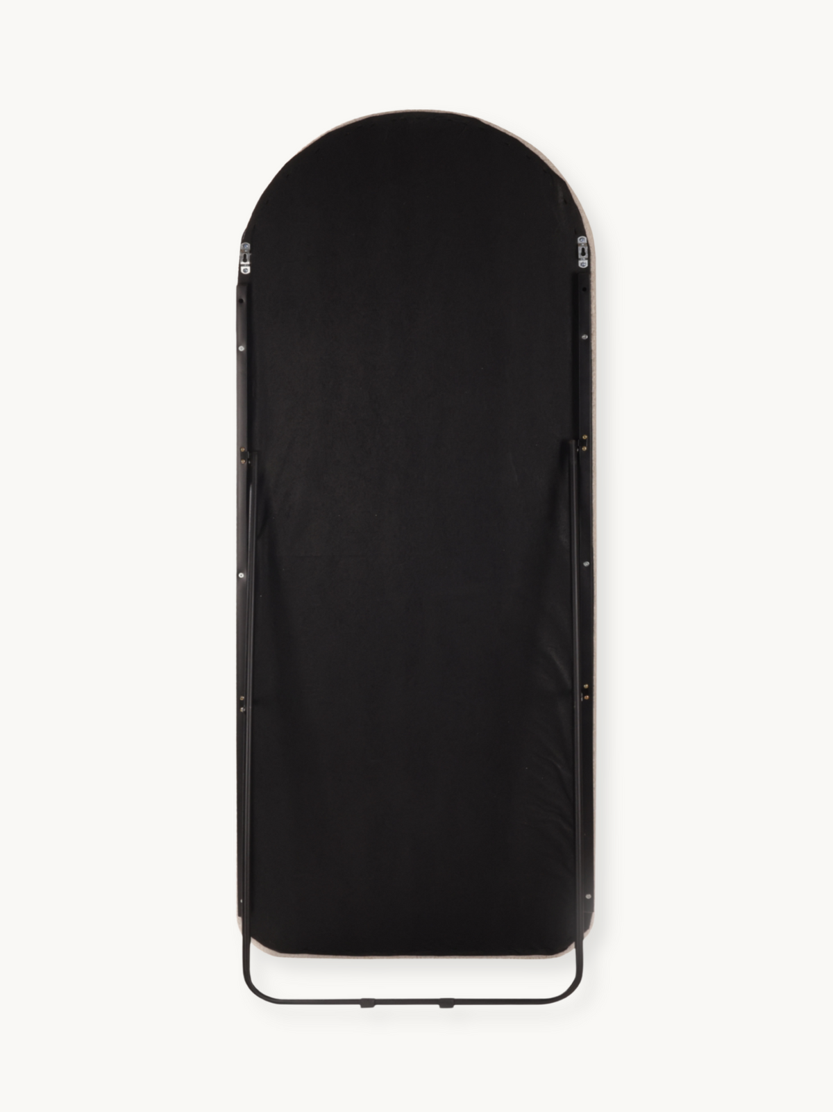 Rear view of arched full-length mirror showing black fabric backing, silver hardware clips, and black metal floor stand br…
