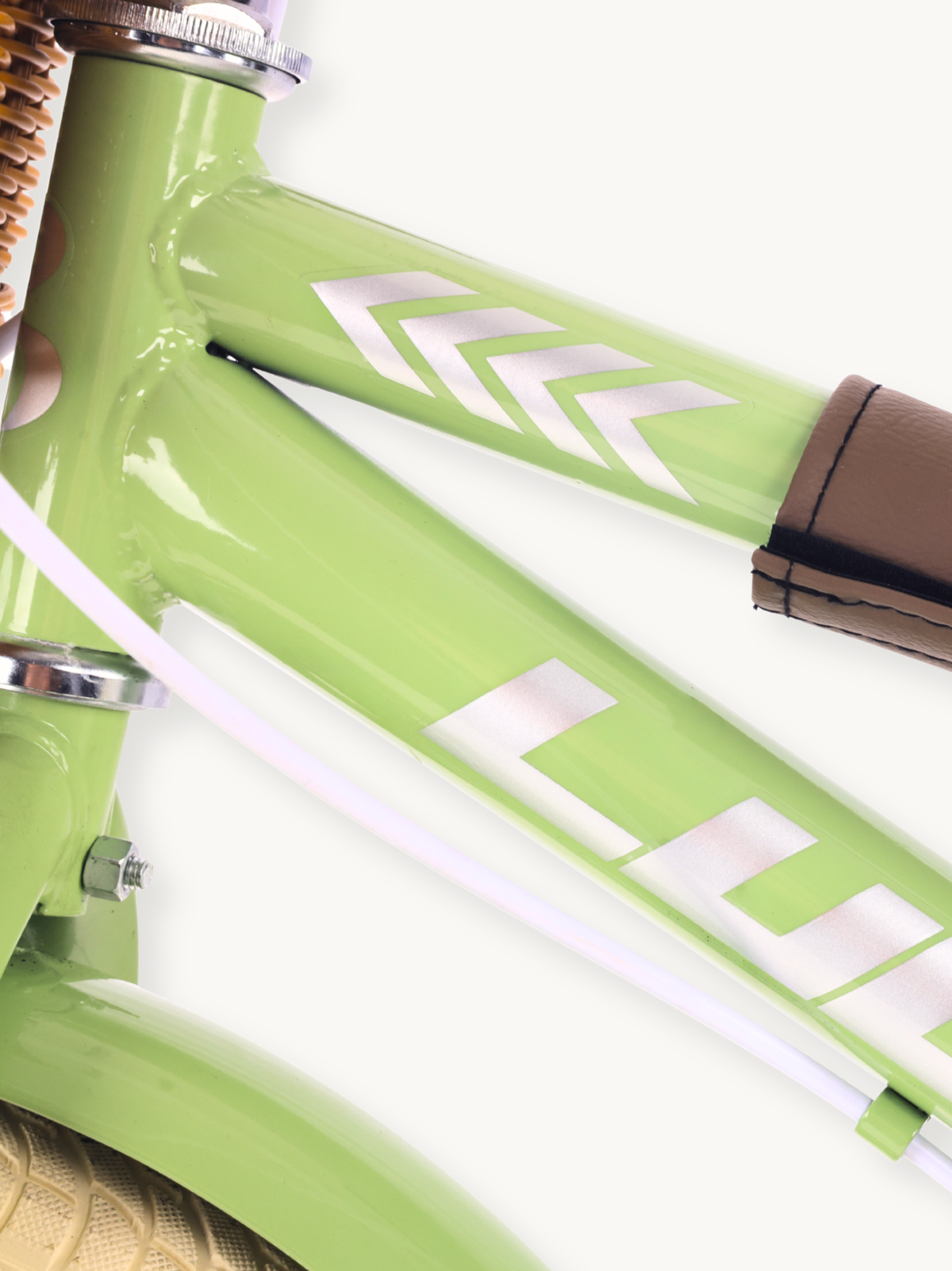 Close-up of lime green carbon steel bike frame with silver chevron decals and brown leather-wrapped handlebar grip end