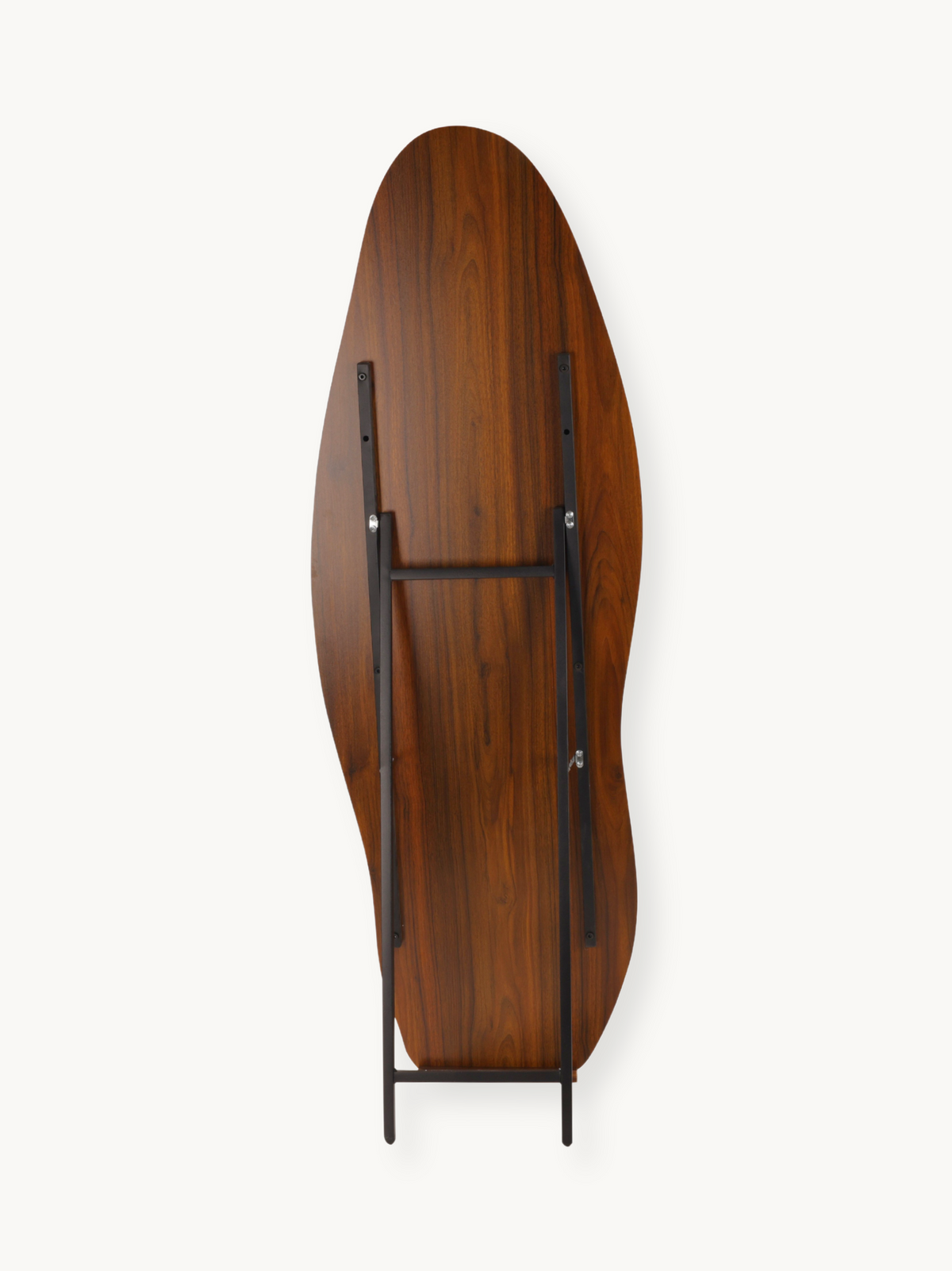 Underside of asymmetric walnut-finish mirror showing black metal easel frame, cross brace, and silver mounting hardware, t…