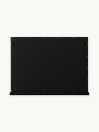 Back panel of black Hollywood vanity mirror showing two keyhole wall-mount brackets and perimeter screws, with a small bot…