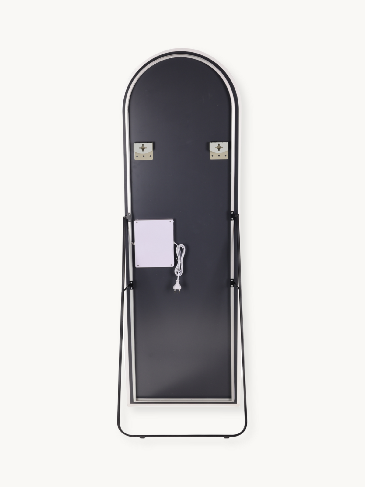 Back view of arched full-length LED mirror on black metal easel stand, showing two wall-mount brackets and white power cab…
