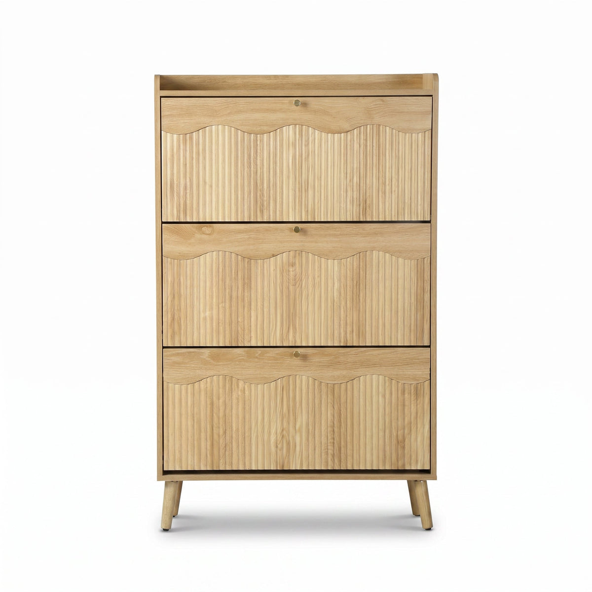 Natural oak shoe cabinet front view, three ribbed flip-down doors with scallop edges, small brass knobs, and angled tapere…