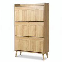 Light oak shoe cabinet with three flip-down ribbed doors, scallop-edge detail, brass knobs, and angled legs, angled front…
