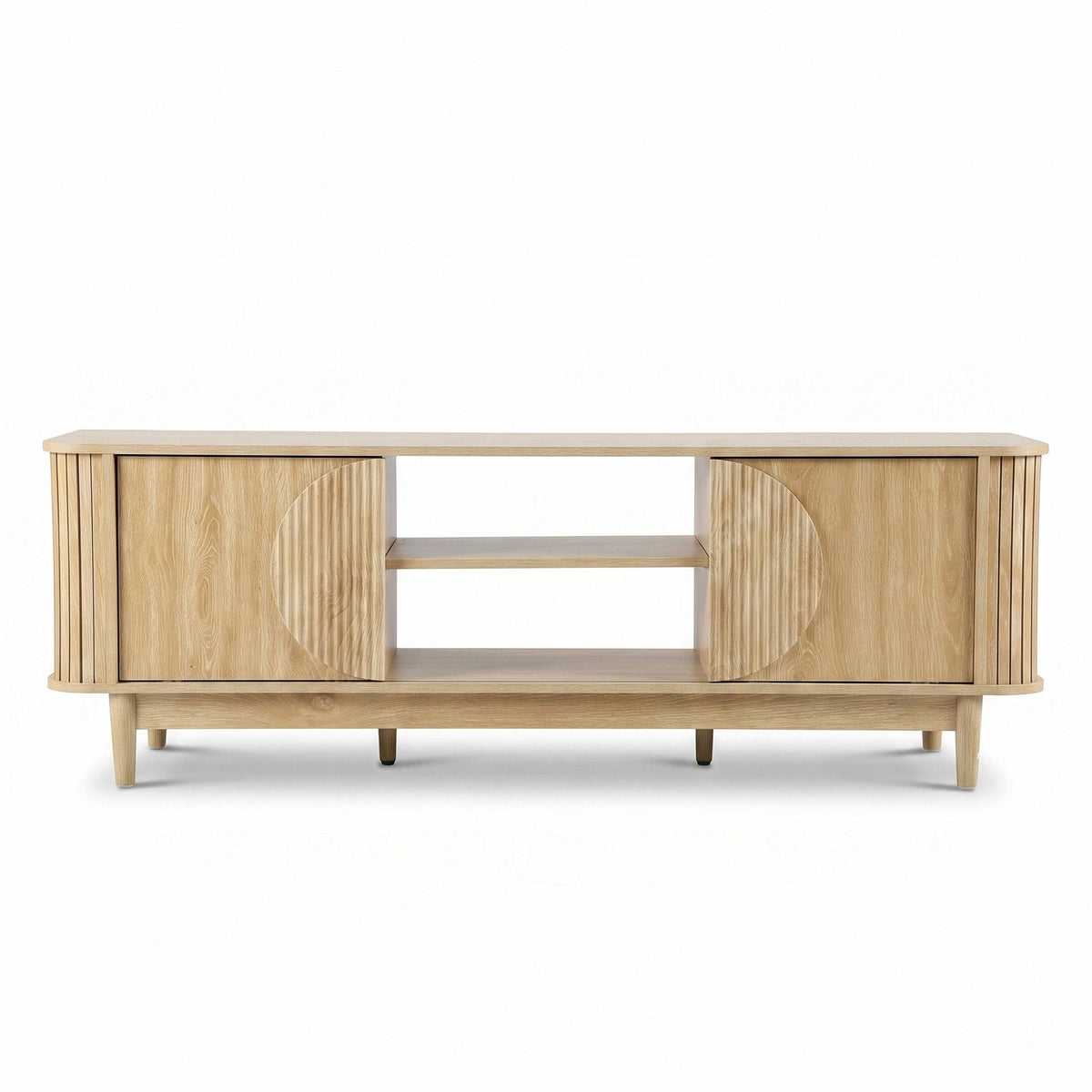 Light oak TV stand front view, ribbed sliding doors with circular detail, two open centre shelves, tapered legs, white bac…
