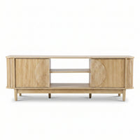 Light oak TV stand front view, ribbed sliding doors with circular detail, two open centre shelves, tapered legs, white bac…