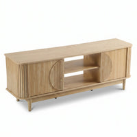 Light oak TV stand with ribbed sliding doors, circular door detail, two open centre shelves, angled legs, three-quarter fr…
