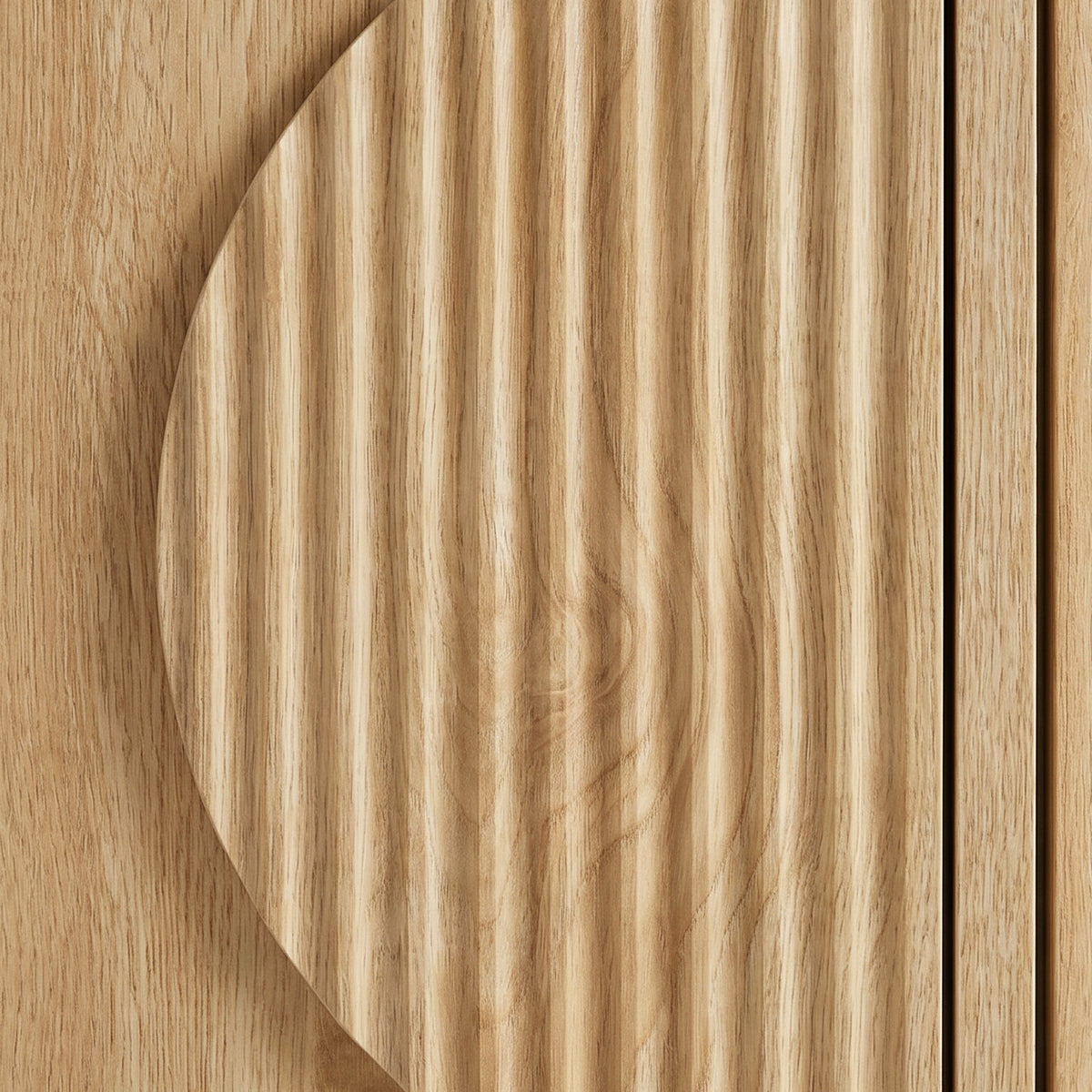 Close-up of circular ribbed door detail on light oak TV stand, showing vertical grain texture contrast against flat panel