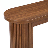 Close-up of walnut-finish console table corner showing rounded oval top edge and vertically fluted cylindrical leg detail