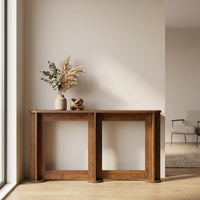 Walnut-finish console table styled in a bright hallway with dried pampas grass, eucalyptus in a ceramic vase, and a sculpt…