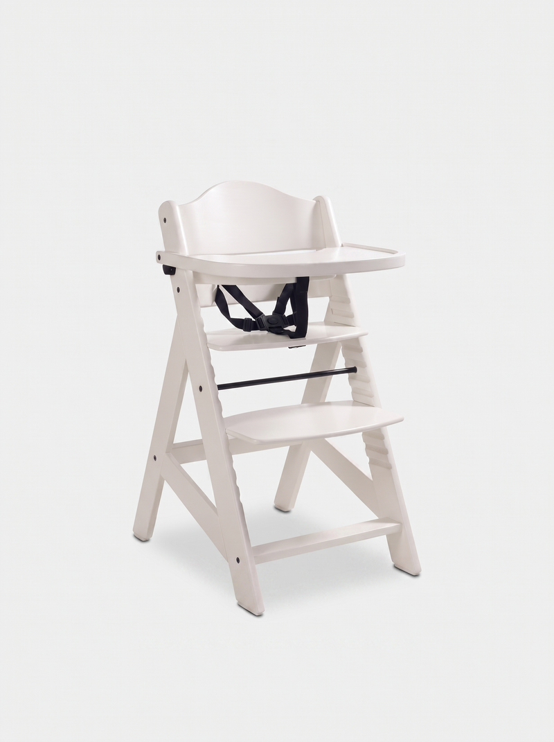 White wooden baby highchair with attached tray and black 5-point safety harness, angled front view on white background
