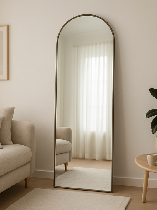 Full-length mirror in a room with a sofa and a small table.