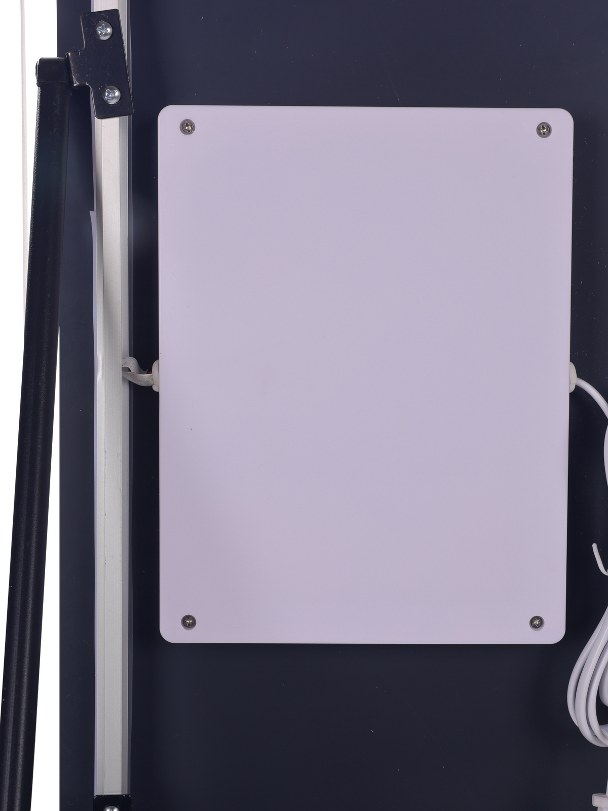 Back of LED mirror panel showing white rectangular control box with four corner screws and white power cable, mounted on d…
