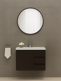 Black-framed round Freya mirror mounted above a dark wood floating vanity in a styled grey bathroom setting