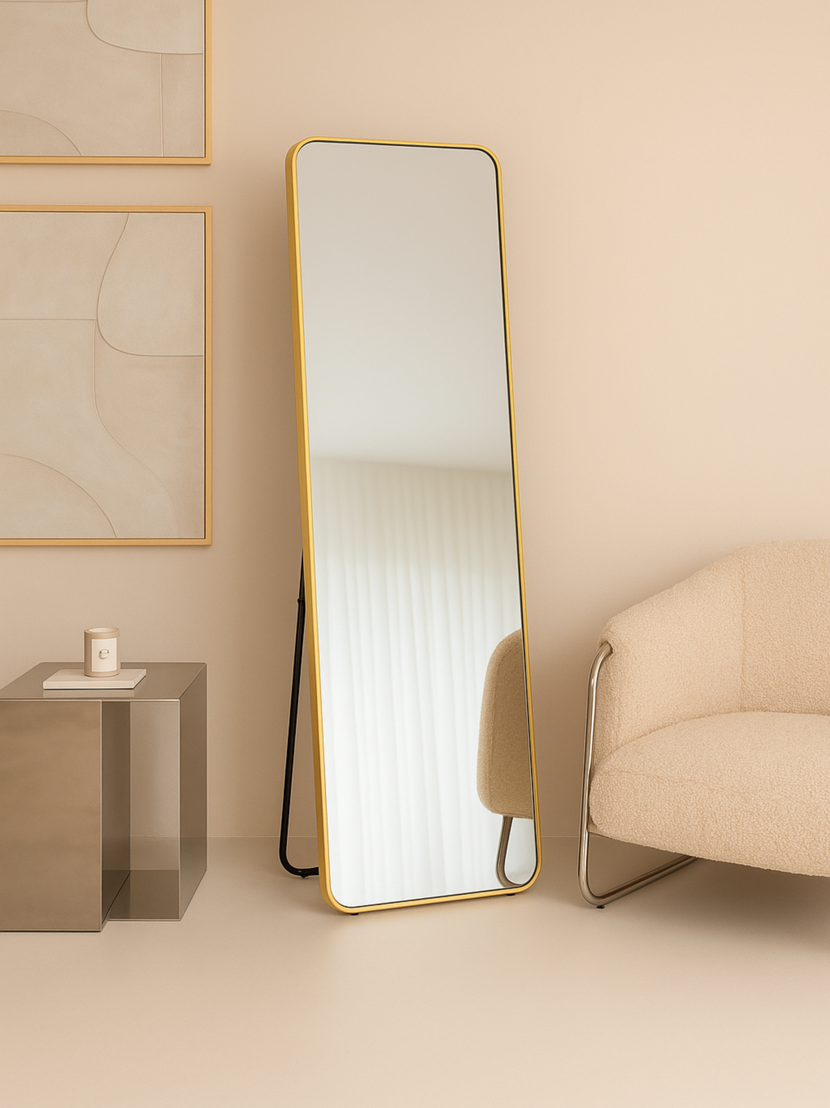 Gold full-length floor mirror with rounded corners leaning against a beige wall, black kickstand visible, beside a cream b…
