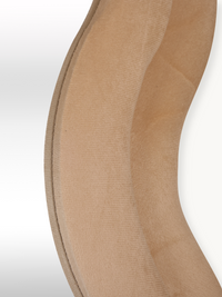 Close-up of taupe beige suede velvet mirror frame edge showing stitched seam detail and curved wavy silhouette
