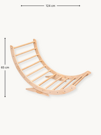 Natural wood climbing arch rocker shown at an angle with dimension annotations: 124 cm wide, 65 cm tall, no cushion attached