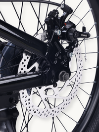 Close-up of Yihao mechanical disc brake caliper and silver rotor on black 20-inch spoked wheel, showing cable routing and…