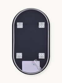 Back of oval LED bathroom mirror showing four white wall-mounting brackets, control box with green indicator, and white po…