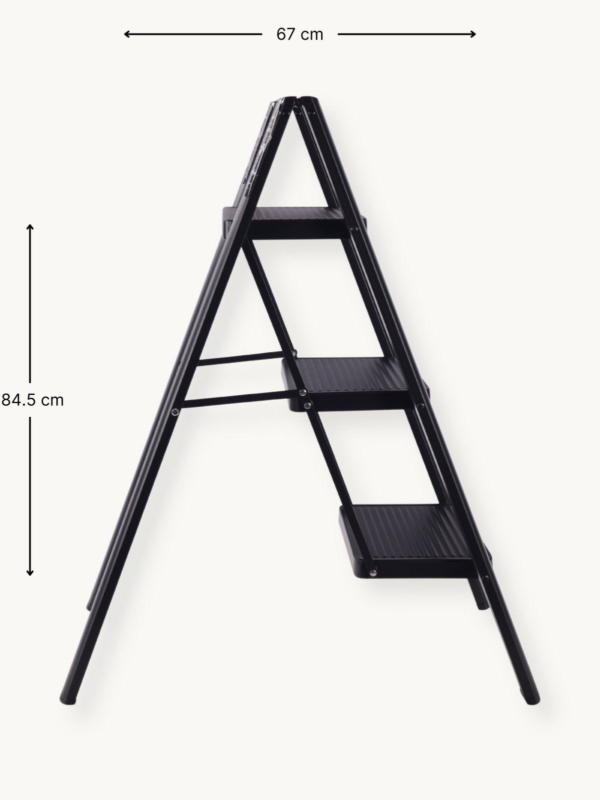 Black 3-step folding ladder angled side view with dimension annotations: 67 cm wide and 84.5 cm tall, white background